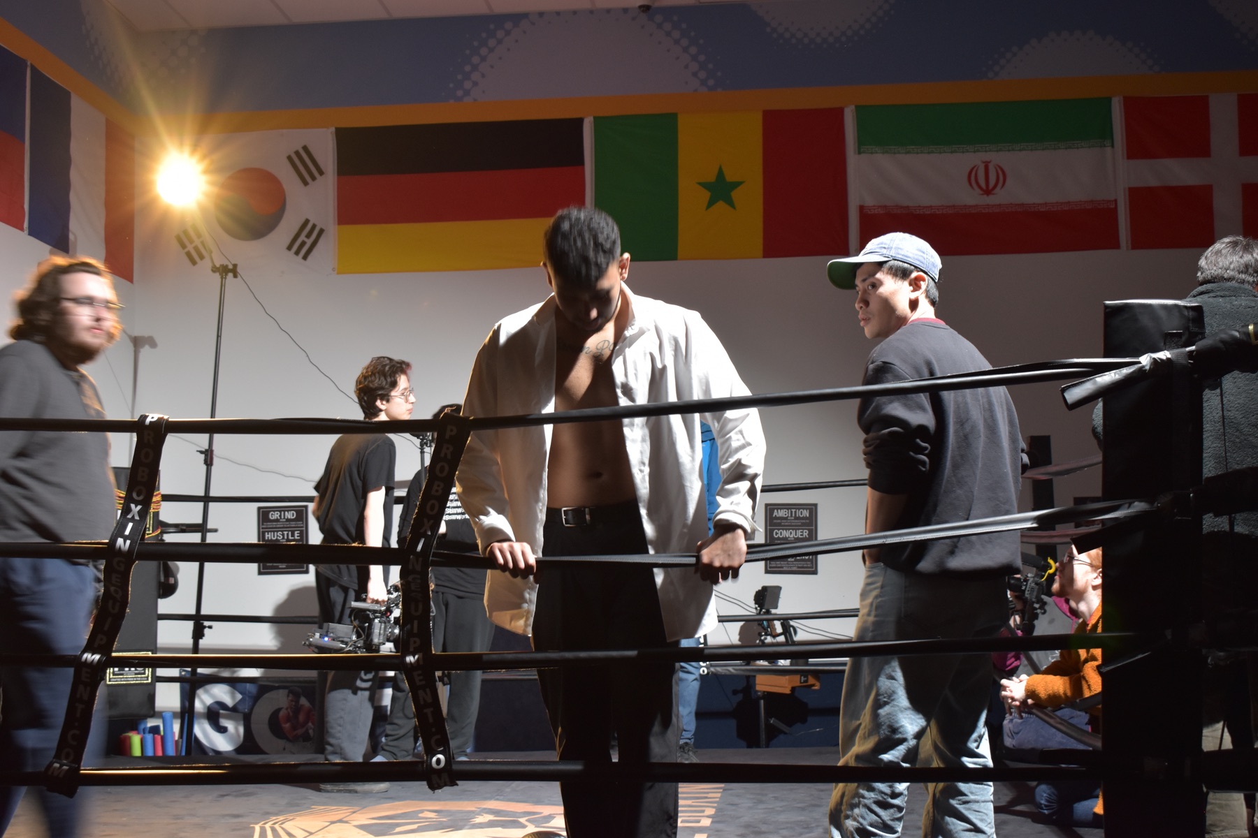Sree in the ring on fight day, surrounded by crew under a set light