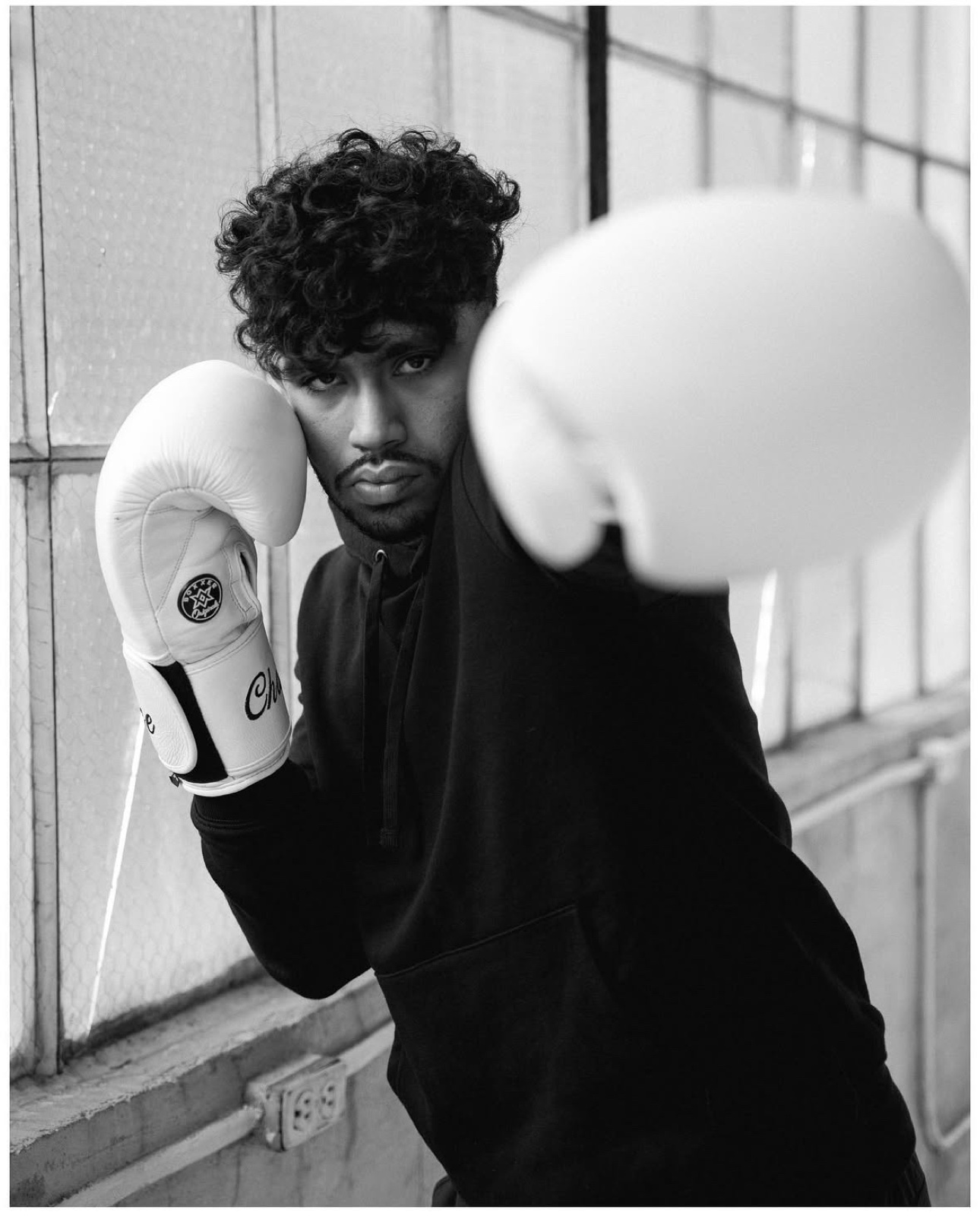 Sree throwing a jab toward the camera in white gloves