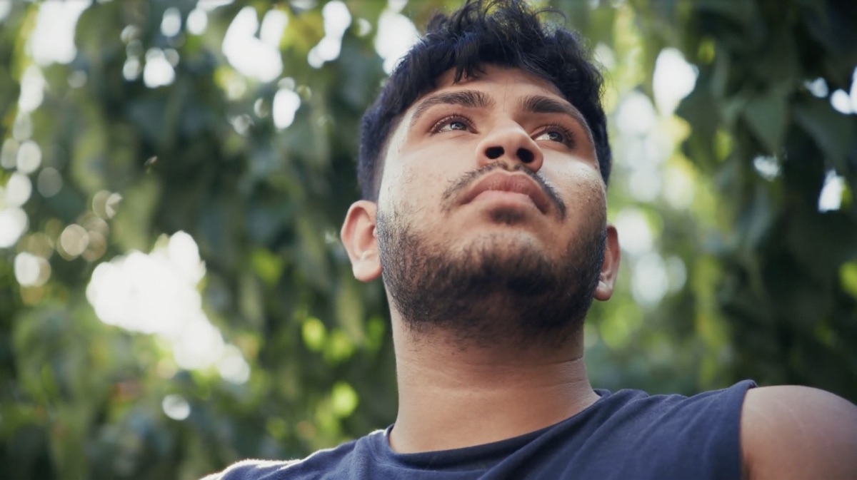 Sree as Sid looking up, hopeful, in daylight