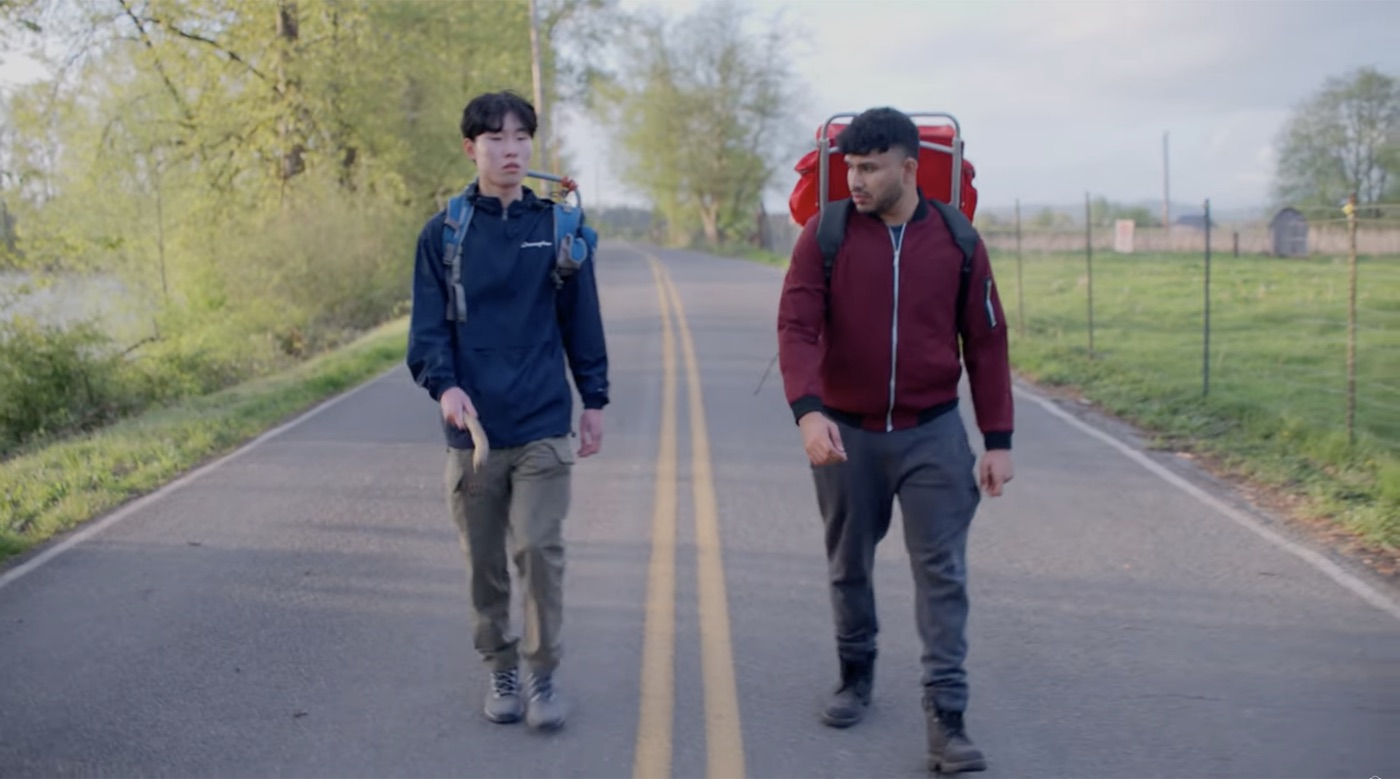 Sree as Anthony hiking a country road with a friend